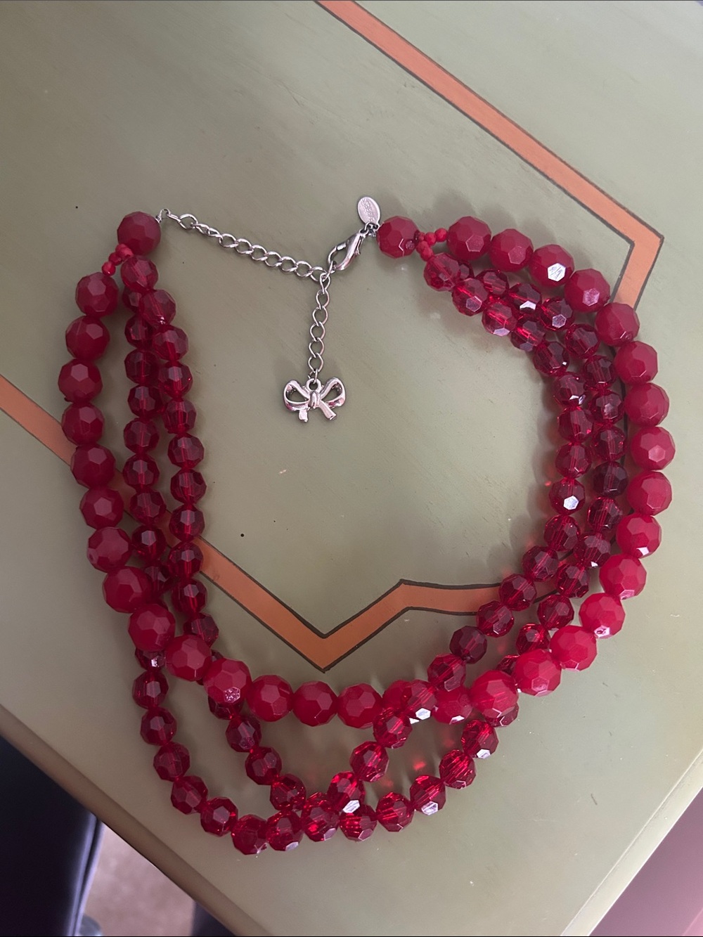 Express Multi-Strand Faceted Red Bead Necklace with Bow Charm